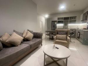 a living room with a couch and a table at Lovely and Cosy 2 bedrooms Space in Rosebank in Johannesburg