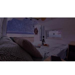 1 dormitorio con 1 cama y una ventana con estrellas en Sleepfurgo, en Las Palmas de Gran Canaria