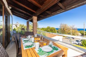 a dining table on the balcony of a house at Appartamento Ogliastra in Santa Maria Navarrese