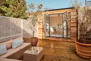 a backyard patio with a couch and a window at 21 Pound Street in Petworth