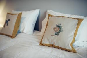 a bed with two pillows on top of it at Pine Apartment in Visaginas