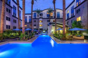 a swimming pool in a hotel with palm trees at Loft with Views-King Beds-Shop & Dine-1mi & Parking 4058 in Phoenix