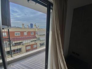 a window in a room with a view of a building at Lux Apartment 02 + Free Parking Post in Tirana
