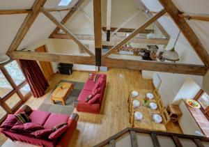 an overhead view of a living room with red furniture at The Hay House in Thursford