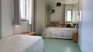 Postel nebo postele na pokoji v ubytování WEAA Hotel