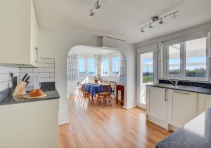 a kitchen and dining room with a table and chairs at The Lookout -Cromer in Cromer