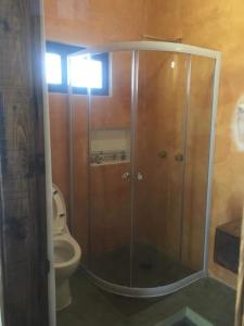 a bathroom with a glass shower with a toilet at Casa Arrecife - Cozy Suite, Fast Wifi & Balcony! Beach is steps away! in La Ventana