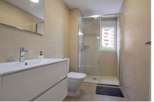 a bathroom with a shower and a toilet and a sink at The perfect holiday apartment with fantastic views in Faro de Cullera +26 photos