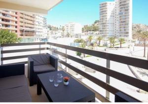 a balcony with a table with glasses on it at The perfect holiday apartment with fantastic views in Faro de Cullera
