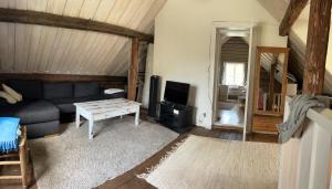 a living room with a couch and a table at Brännkärrstorpet B&B in Knivsta