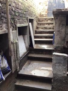 an old staircase in a building with a brick wall at The Bunker in Manchester