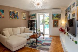 a living room with a couch and a table at Art & Gallery Vacation Home in Korčula