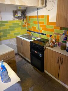 a kitchen with a stove and a sink in it at The Bunker in Manchester