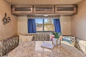a small room with a table and a window at JT Village Campground - Lil Miss Daisy in Joshua Tree