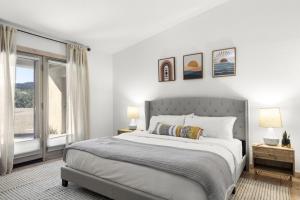 a white bedroom with a large bed and a window at A WFH Resort in Paradise Valley in Scottsdale