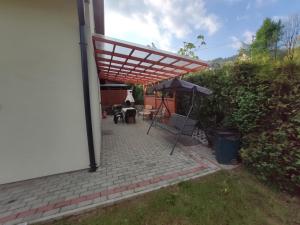 a patio with an umbrella and a table at Domek Pod Górą Żar in Międzybrodzie Żywieckie