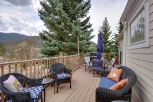 a deck with chairs and tables and a tree at Empire Vacation Rental with Fire Pit and Gas Grill! in Empire