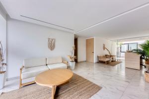 a living room with a couch and a table at Lumina at Cardinal San José del Cabo in San José del Cabo