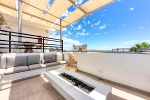 a living room with a couch and a large window at Lumina at Cardinal San José del Cabo in San José del Cabo
