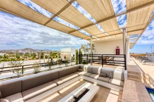 a living room with a couch on a balcony at Lumina at Cardinal San José del Cabo in San José del Cabo