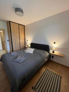 una camera da letto con un letto e due asciugamani di Apartament w Dolinie Sanu 2 a Lesko
