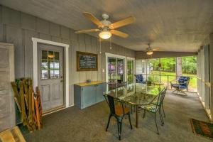 a dining room with a ceiling fan and a glass table at Evergreen in Moneta