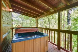 a hot tub on the deck of a tree house at Gatlinburg Cabin with Hot Tub about 6 Mi to Downtown! in Gatlinburg