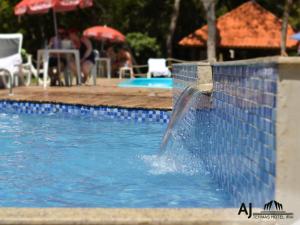 a water fountain in a swimming pool at AJ TERMAS HOTEL IRAÍ in Iraí +223 photos