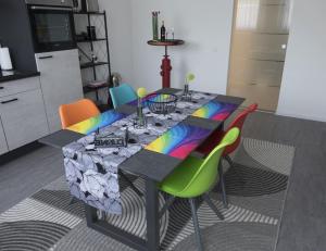 a dining room with a table with colorful chairs at Ferienwohnung 90 m2 in Sulzbach 2 Minuten Fußweg zum Krankenhaus in Sulzbach