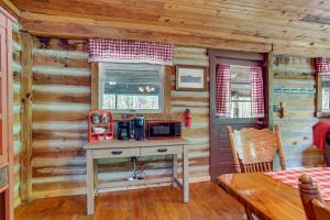 a kitchen with a desk in a log cabin at Historic Log Cabin with Porch Near Patoka Lake! in Taswell