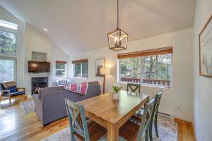 a dining room and living room with a wooden table and chairs at 10 Mi to Sugar Mountain Cozy Newland Cabin! in Newland