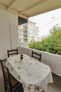 a white table and chairs on a balcony at Hotel Eleana & Apartments in Sarandë +76 photos
