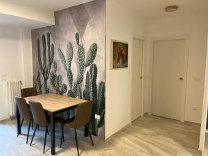 a dining room with a cactus mural on the wall at Villa Giorgia al mare in Bisceglie