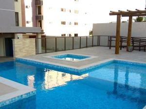 a swimming pool in the middle of a building at DUPLEX com Hidromassagem total de 02 QUARTOS e Vista MAR in Aracaju