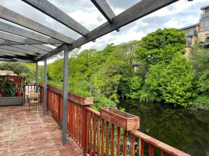 a deck with a view of a river at Serene Riverside Villa - Hidden gem in Dublin City in Dublin
