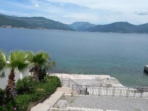 a view of a large body of water with mountains at Apartman Doris in Krašići +10 photos