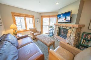 a living room with a couch and a fireplace at Expedition Station 8597 in Keystone