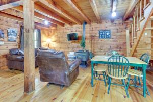 a living room with a leather couch and a table at Comfy Taswell Cabin Rental - Community Amenities! in Taswell