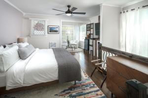 a bedroom with a bed and a ceiling fan at The Victorian Inn Blowing Rock in Blowing Rock