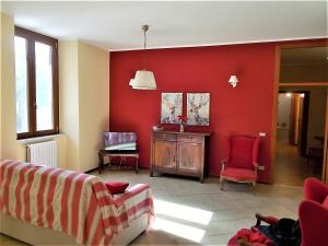 a living room with red walls and red chairs at Angelica in Pisciotta