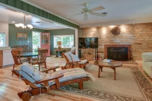 a living room with a fireplace and a stone wall at Waterfront Annapolis Home Fire Pit and Fishing Pier in Annapolis