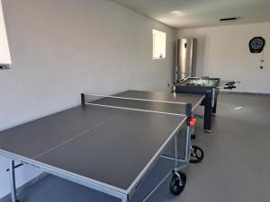 a ping pong table in a room at Veselá lama U nás doma in Baška