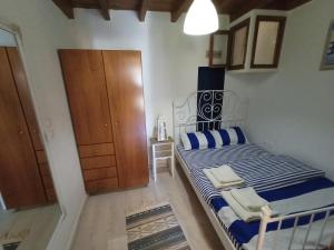 a bedroom with a bed with blue and white sheets at The White House of Rhodes in Rhodes Town