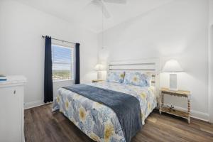 a bedroom with a large bed and a window at Laketown Wharf #2011 by Nautical Properties in Panama City Beach