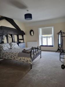 a bedroom with a large bed and a window at The Hideaway in Chapel en le Frith