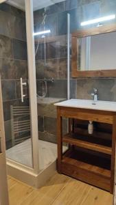 a bathroom with a shower and a sink and a mirror at Appartement Valmeinier 6pers in Valmeinier