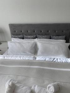 a bed with white sheets and pillows on it at Markt1 in Perleberg