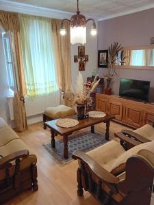a living room with a coffee table and a tv at Dusica in Vrnjačka Banja