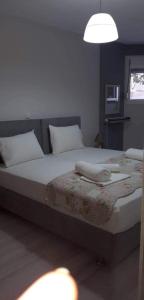 a bedroom with a bed with a phone on it at Nikiana Family Apartment in Nikiana