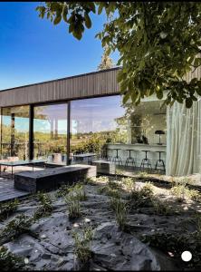 ein Haus mit Glaswänden und einer Terrasse in der Unterkunft Chez Arthur in Marche-en-Famenne